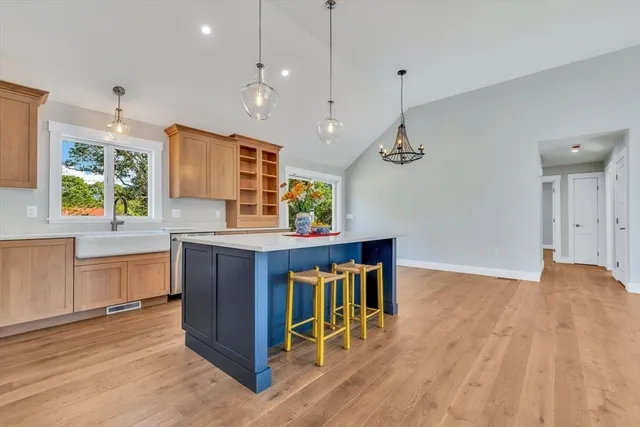 a kitchen with stainless steel appliances granite countertop a stove a sink dishwasher and a wooden cabinets