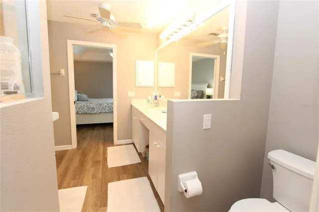 a en suite bathroom with a sink a toilet a mirror and shower