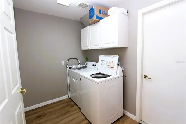 a utility room with sink dryer and washer