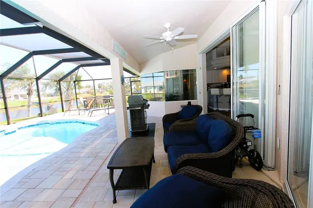 a living room with furniture and a floor to ceiling window