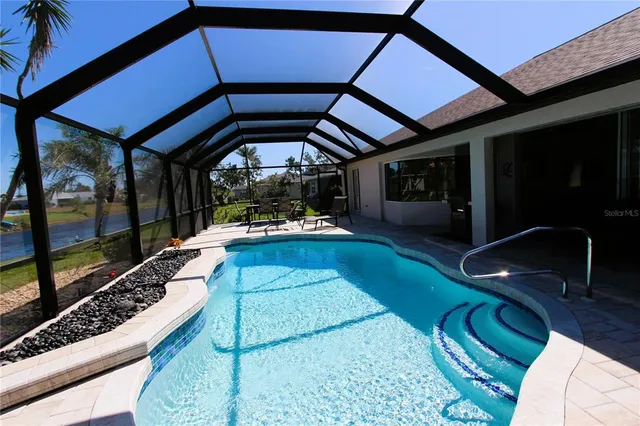 a view of a swimming pool with a patio