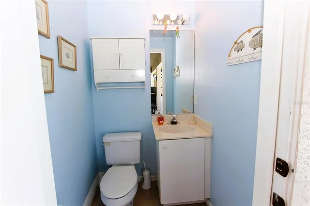 a bathroom with a toilet sink and mirror