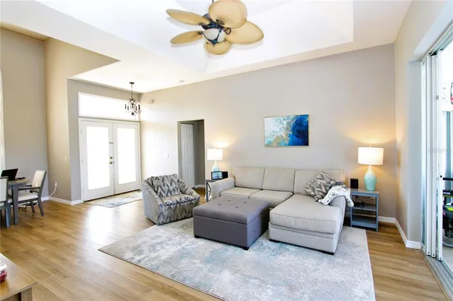 a living room with furniture and wooden floor