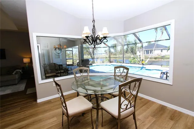 a dining room with furniture wooden floor a chandelier