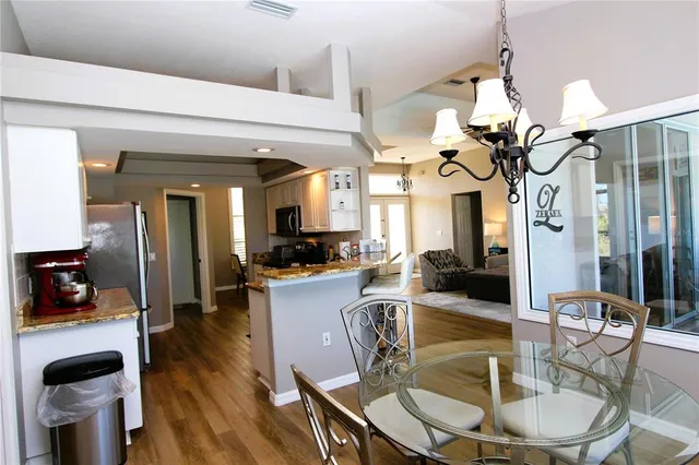 a view of a dining room with furniture and wooden floor