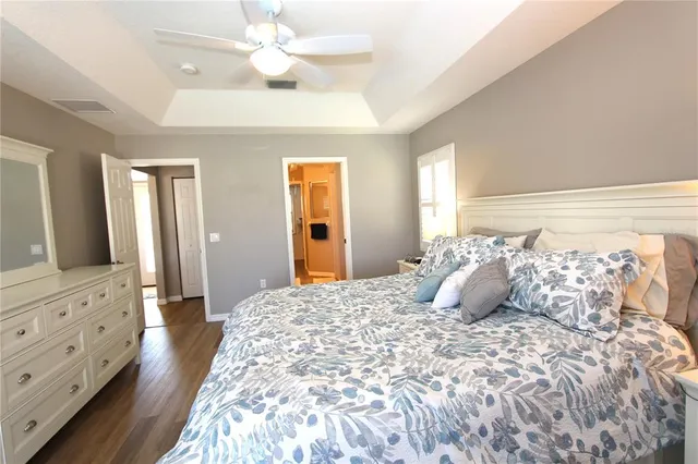 a bedroom with a large bed and a chandelier
