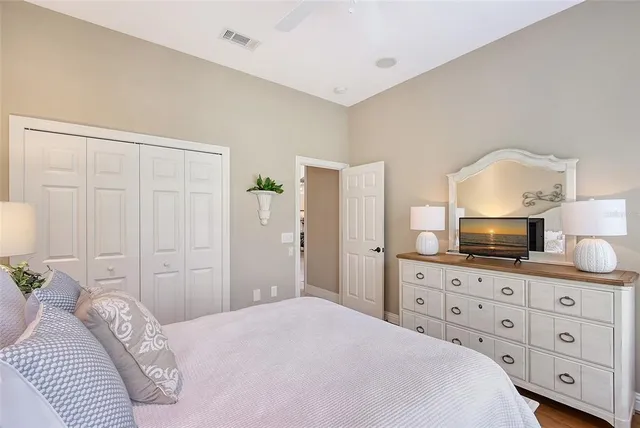 a front view of a house with garden and trees