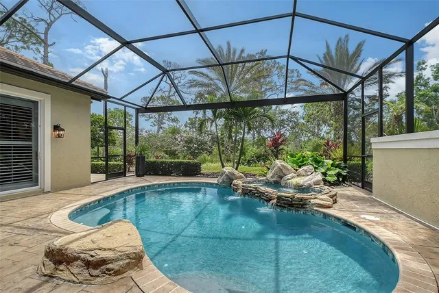 a view of a ocean with a table chairs and a swimming pool