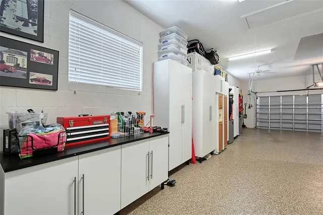 a living room with furniture a chandelier and a dining table