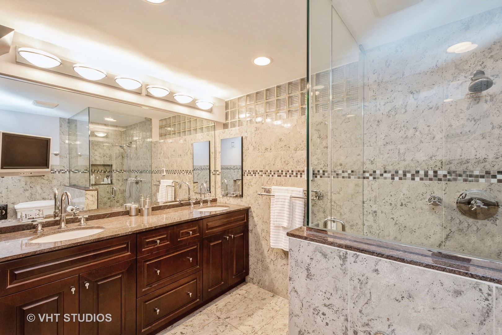 1000 North State Street, Unit 13 Chicago, IL 60610 - Photo 15 of 45 a bathroom with a double vanity sink mirror and shower
