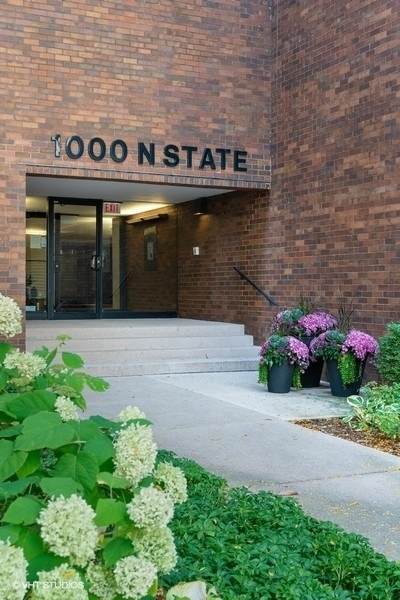 1000 North State Street, Unit 13 Chicago, IL 60610 - Photo 2 of 45 a front view of a building with flowers