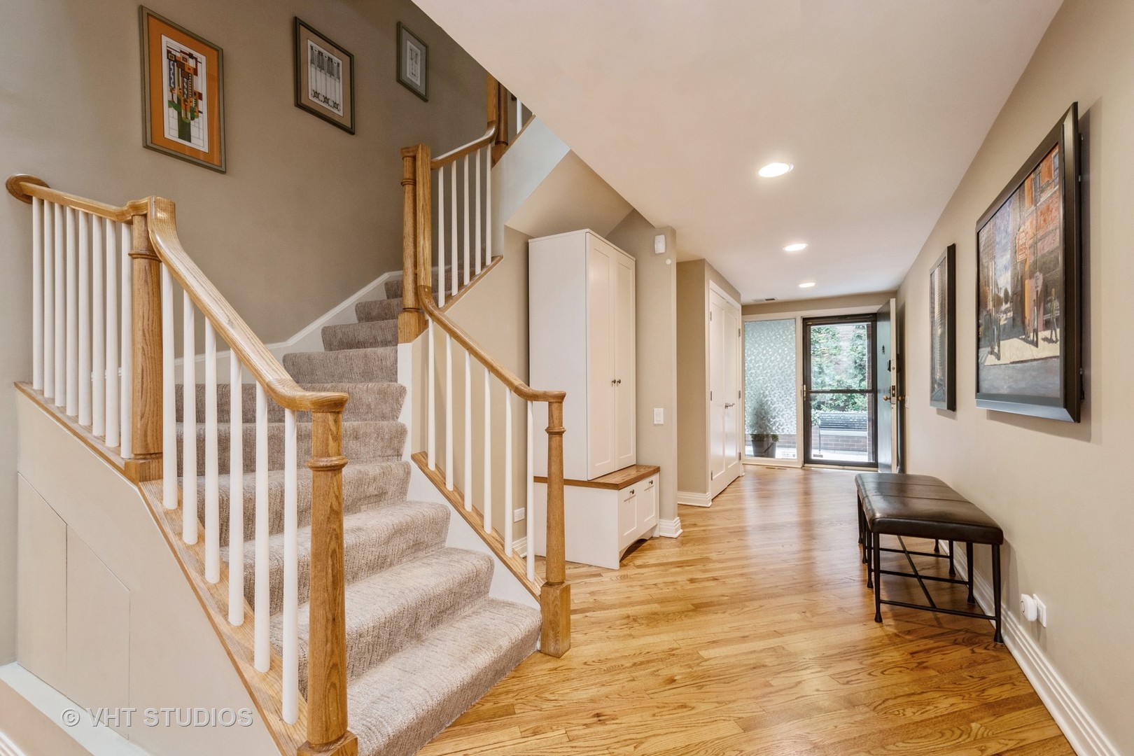 1000 North State Street, Unit 13 Chicago, IL 60610 - Photo 4 of 45 a view of staircase with lots of frames on wall and a dining table