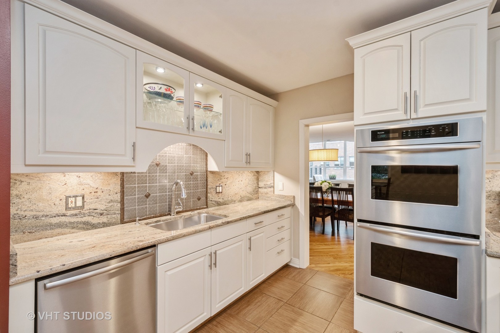 1000 North State Street, Unit 13 Chicago, IL 60610 - Photo 10 of 45 a kitchen with stainless steel appliances granite countertop a stove a sink and a microwave