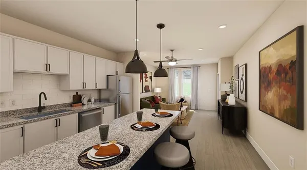 a kitchen with stainless steel appliances granite countertop a sink a stove and refrigerator