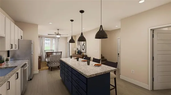 a kitchen with a sink a counter space appliances and cabinets