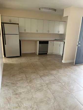 a view of kitchen with white cabinets