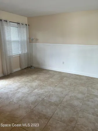 an empty room with cabinet and mirrors