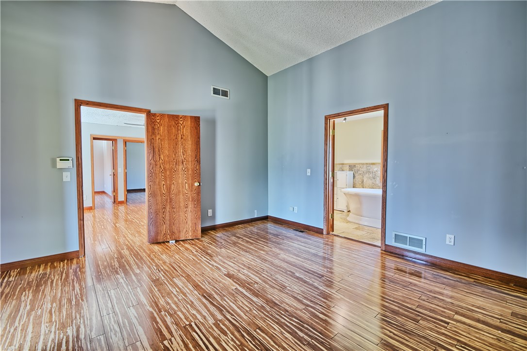 8711 Nicole Lane Springboro, OH 45066 - Photo 41 of 87 This primary bedroom features high ceilings and polished wood flooring, offering a serene and spacious retreat.