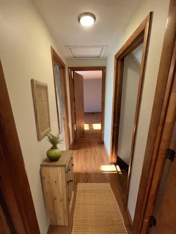 a view of a hallway with wooden floor