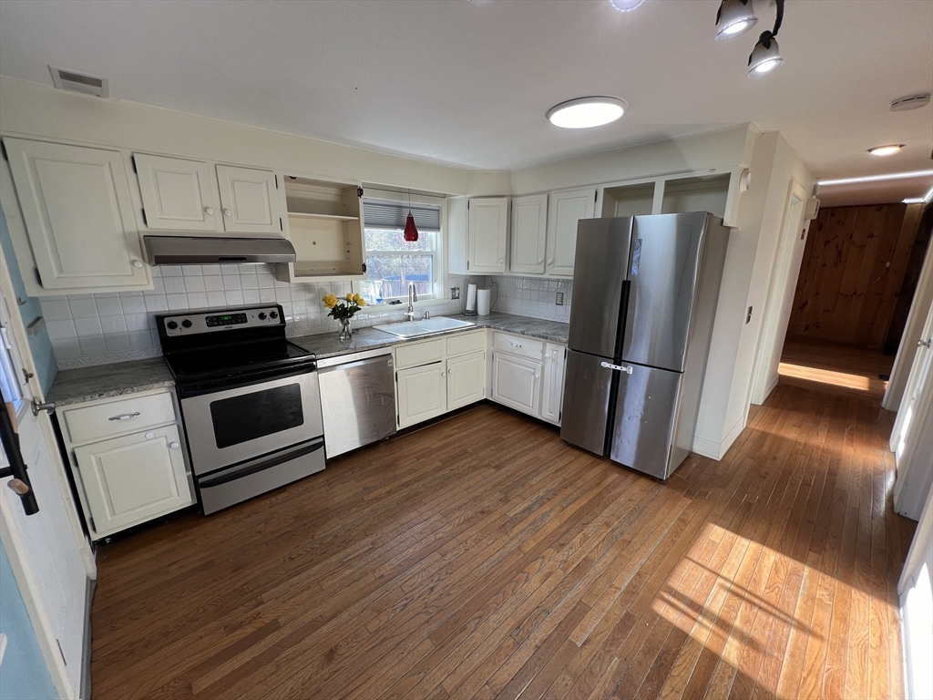 960 Westhampton Road Northampton, MA 01062 - Photo 2 of 30 a kitchen with wooden floors and stainless steel appliances