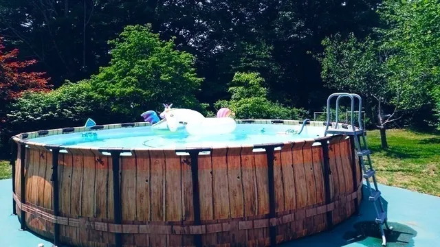 a view of a swimming pool with an outdoor seating and a yard