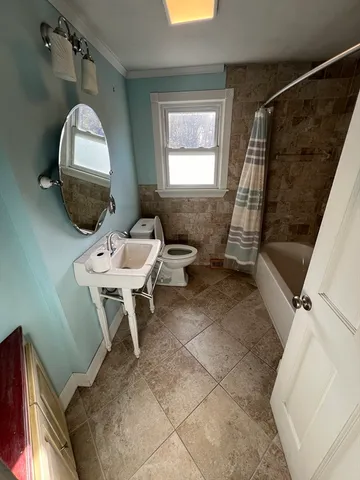 a bathroom with a sink toilet and a mirror