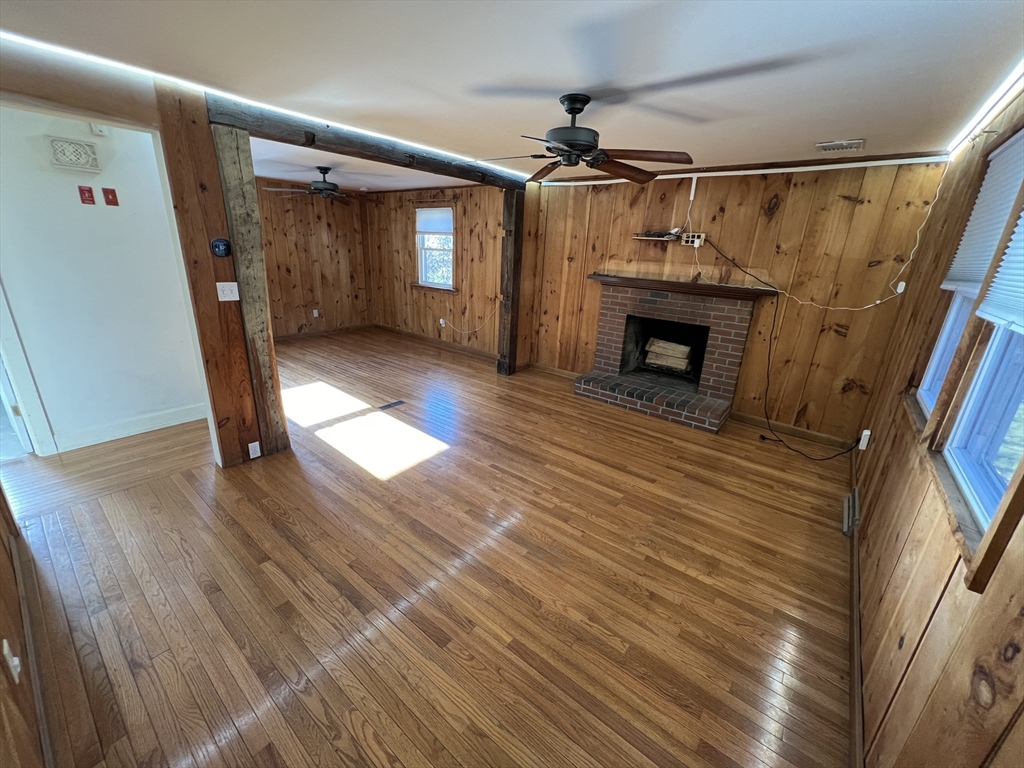 960 Westhampton Road Northampton, MA 01062 - Photo 6 of 30 a view of a livingroom with wooden floor and a fireplace