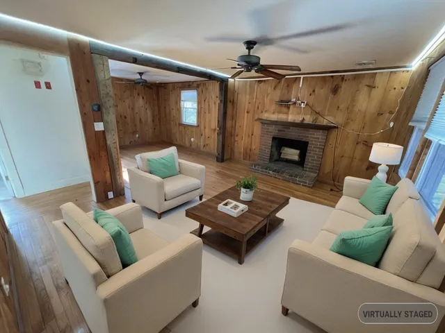 a living room with furniture and a fireplace