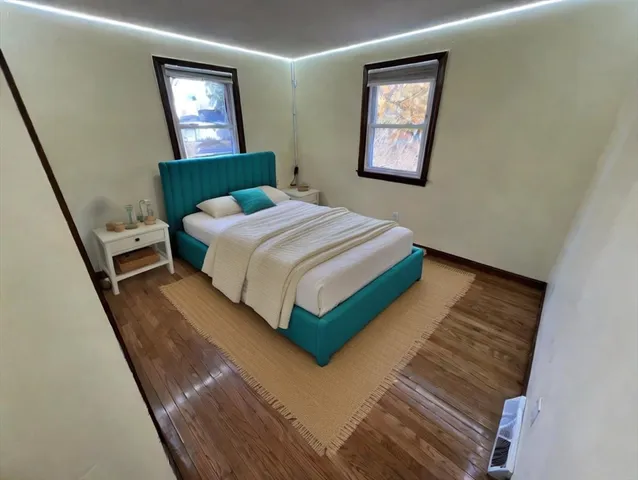 a bedroom with a bed lamp and a window