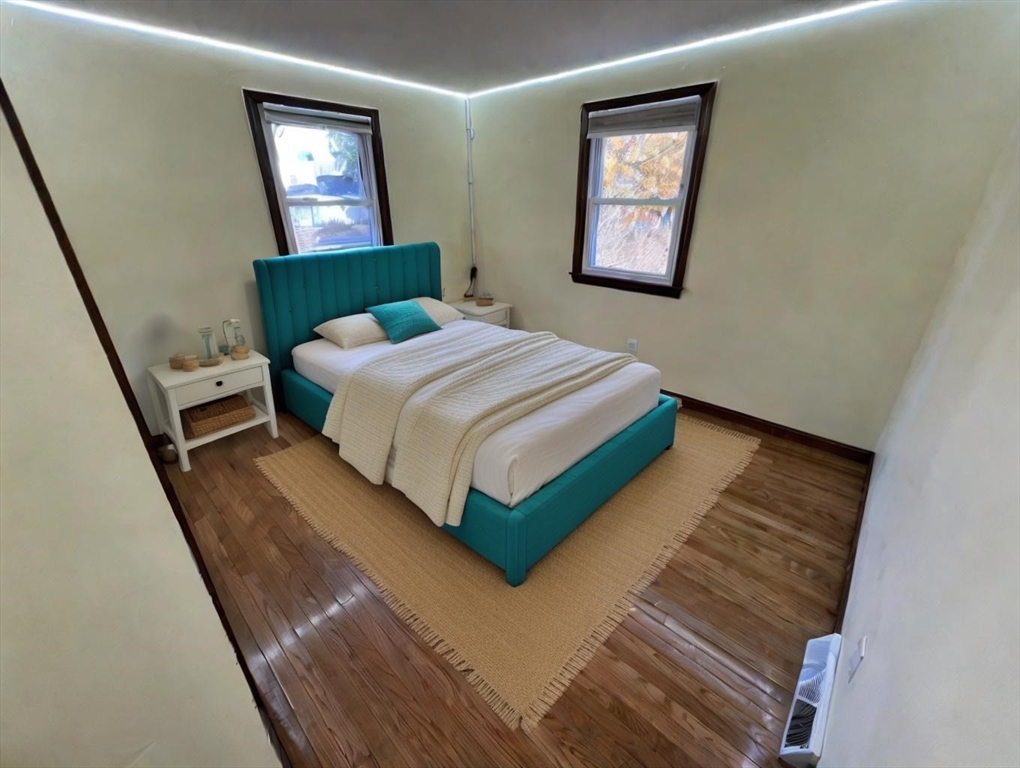 960 Westhampton Road Northampton, MA 01062 - Photo 10 of 30 a bedroom with a bed lamp and a window