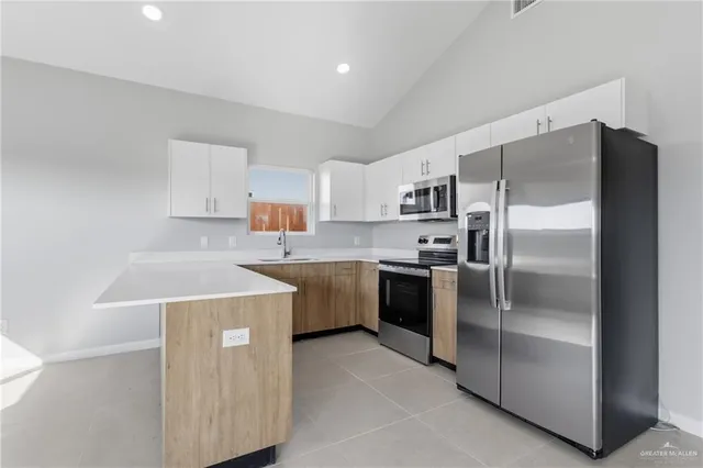 a kitchen with a refrigerator sink and stove