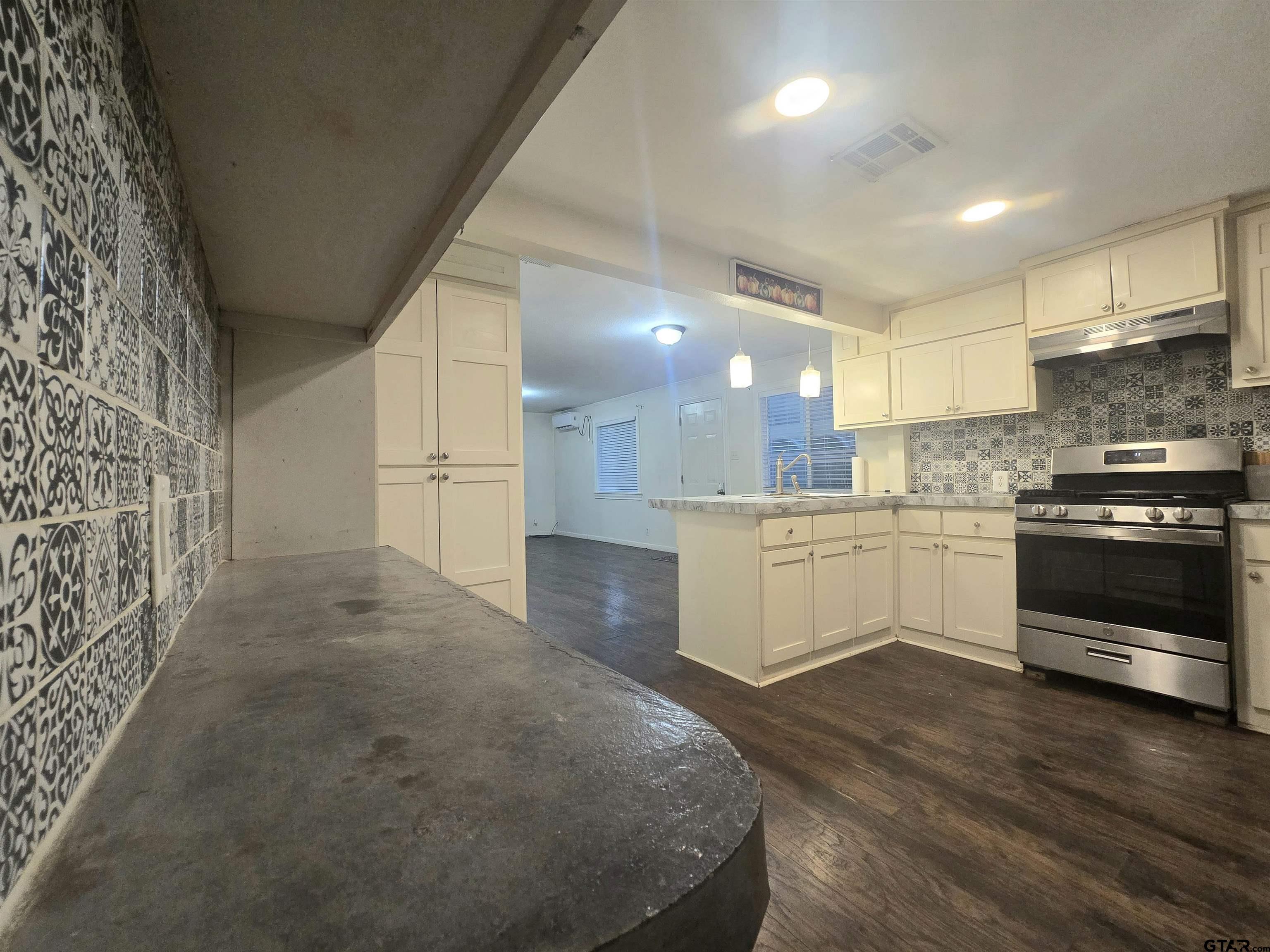 3623 New Copeland Road Tyler, TX 75701 - Photo 18 of 42 a view of a kitchen with a sink and a stove top oven