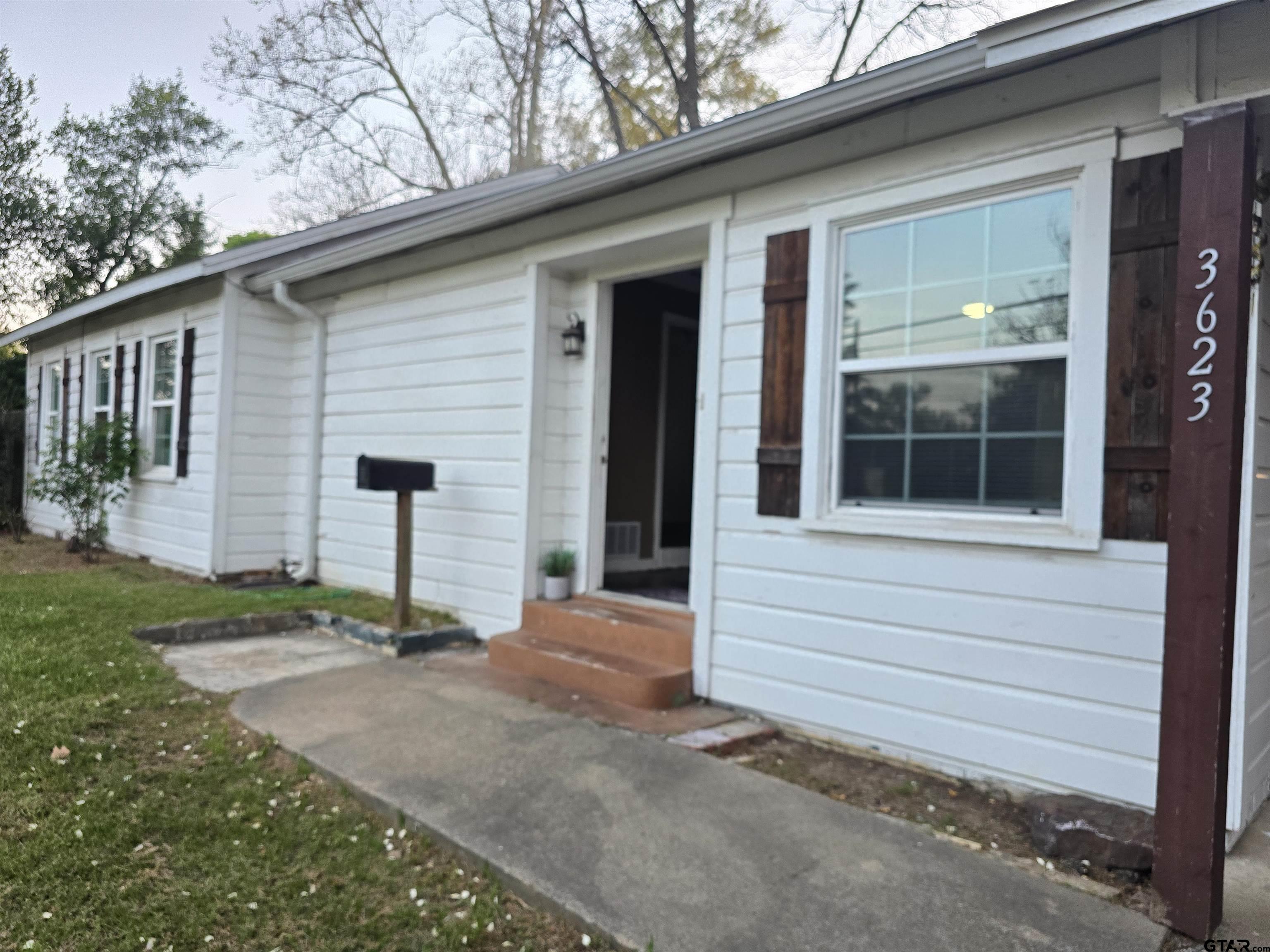 3623 New Copeland Road Tyler, TX 75701 - Photo 2 of 42 a front view of a house with a garden