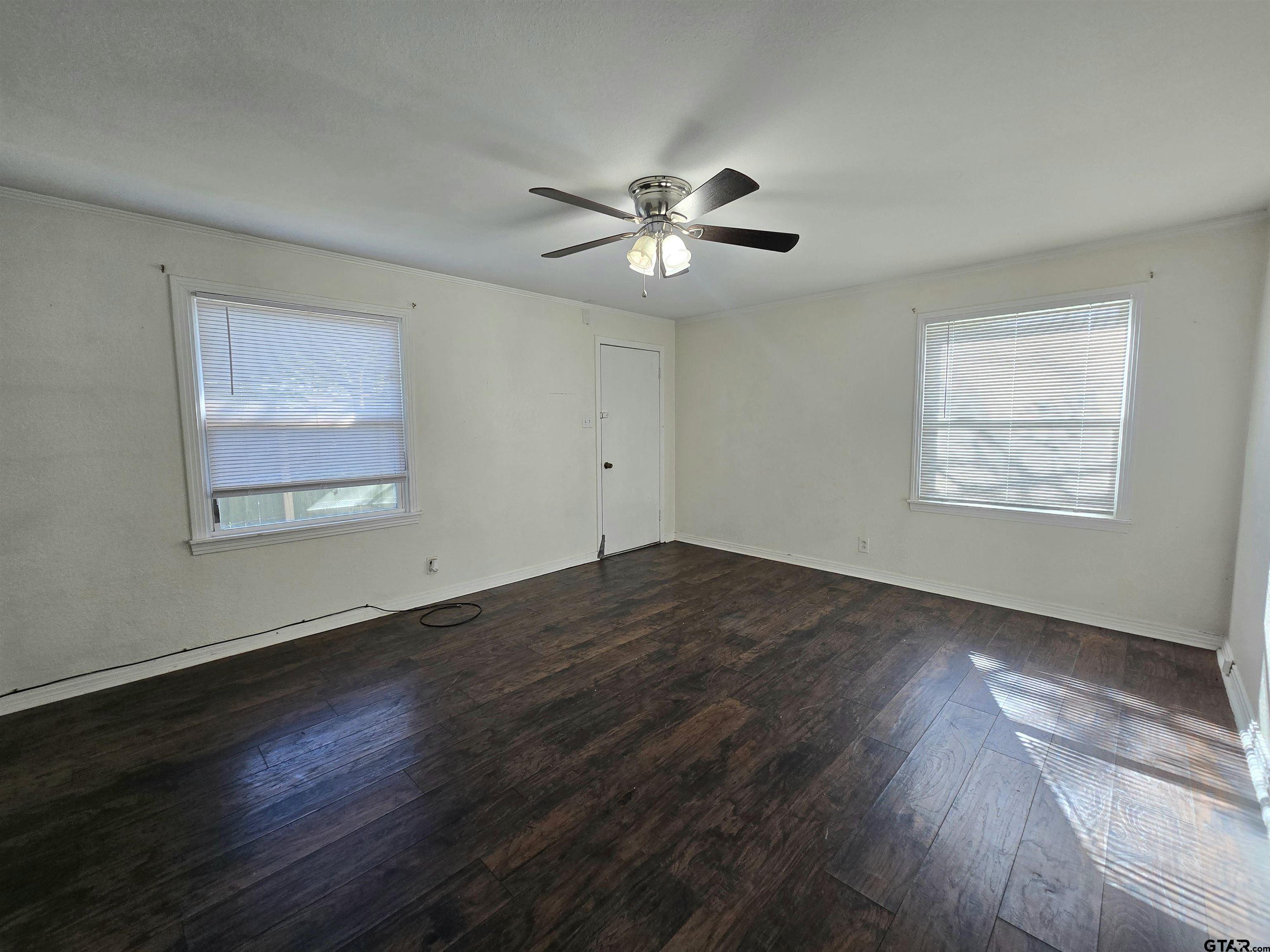 3623 New Copeland Road Tyler, TX 75701 - Photo 21 of 42 a view of an empty room with wooden floor and a window