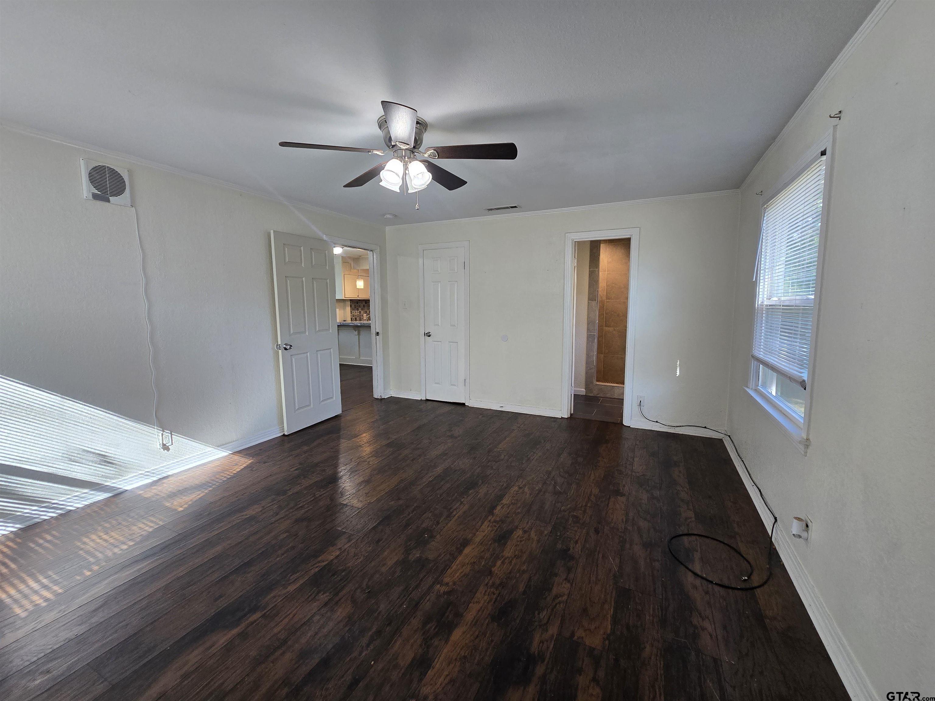 3623 New Copeland Road Tyler, TX 75701 - Photo 22 of 42 a view of empty room with wooden floor and fan