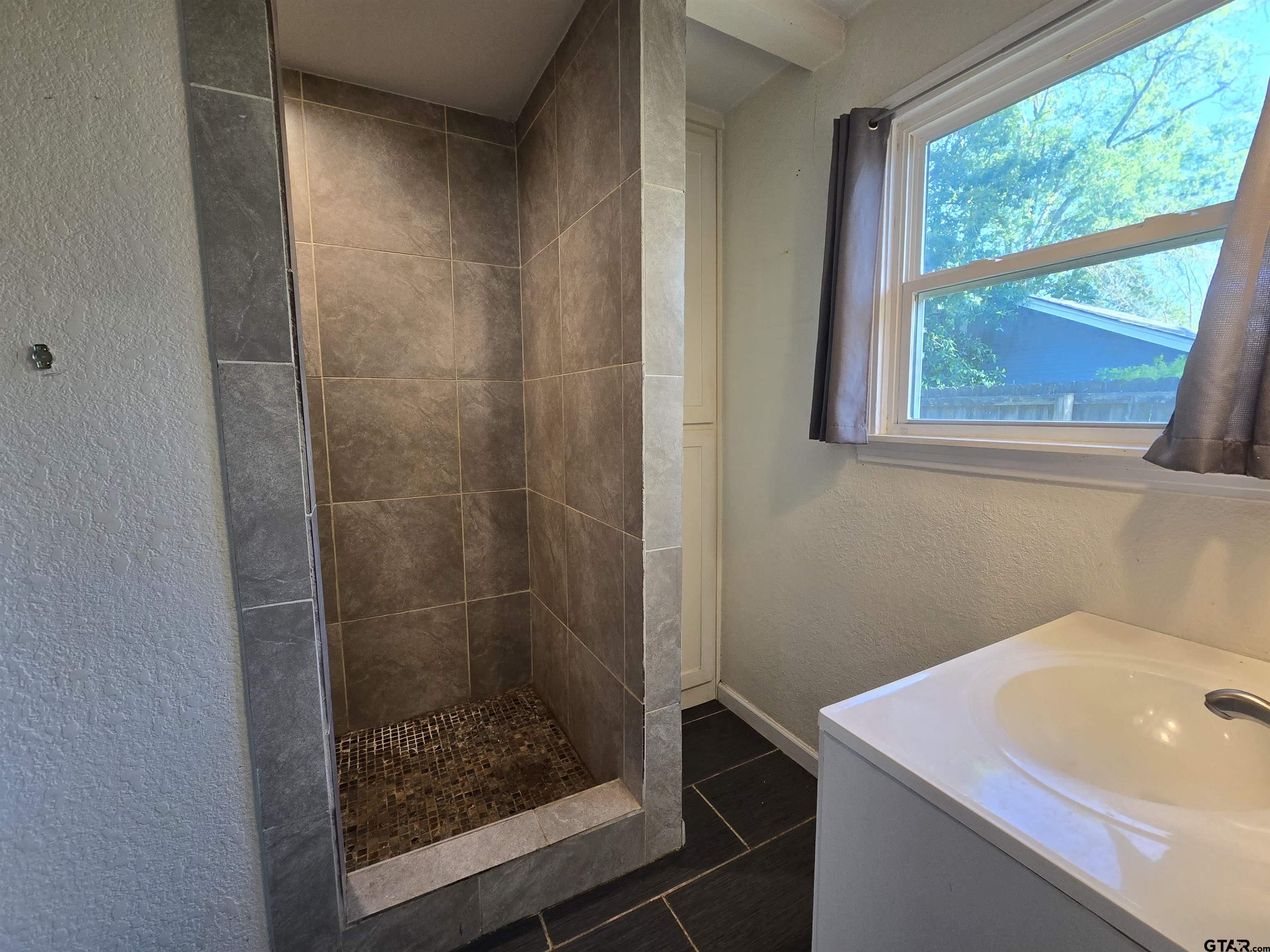 3623 New Copeland Road Tyler, TX 75701 - Photo 25 of 42 a bathroom with a sink and a shower