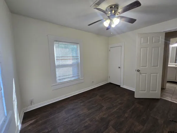 a view of a yard in front of a house with large trees