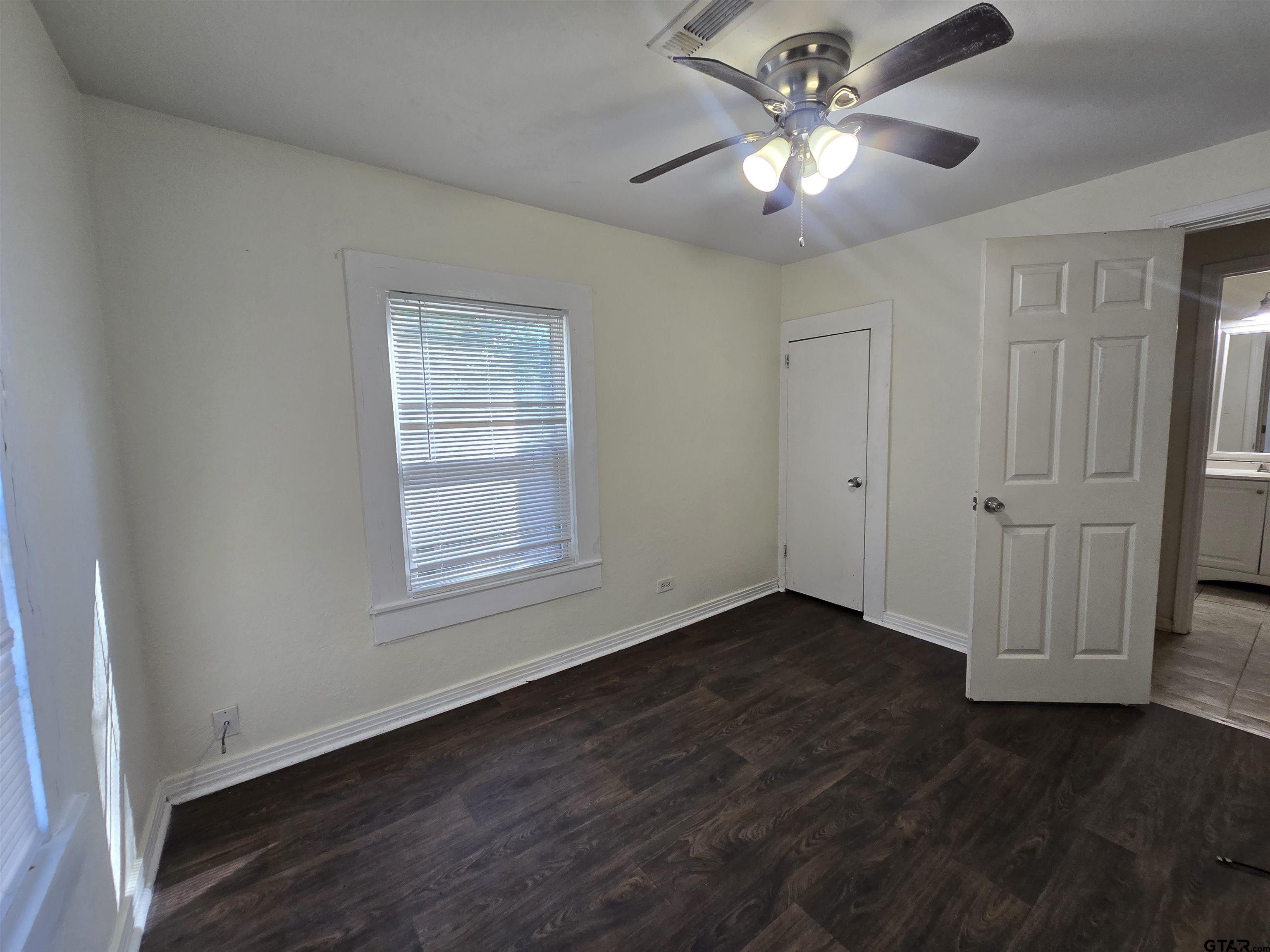 3623 New Copeland Road Tyler, TX 75701 - Photo 26 of 42 a view of an empty room with window and wooden floor