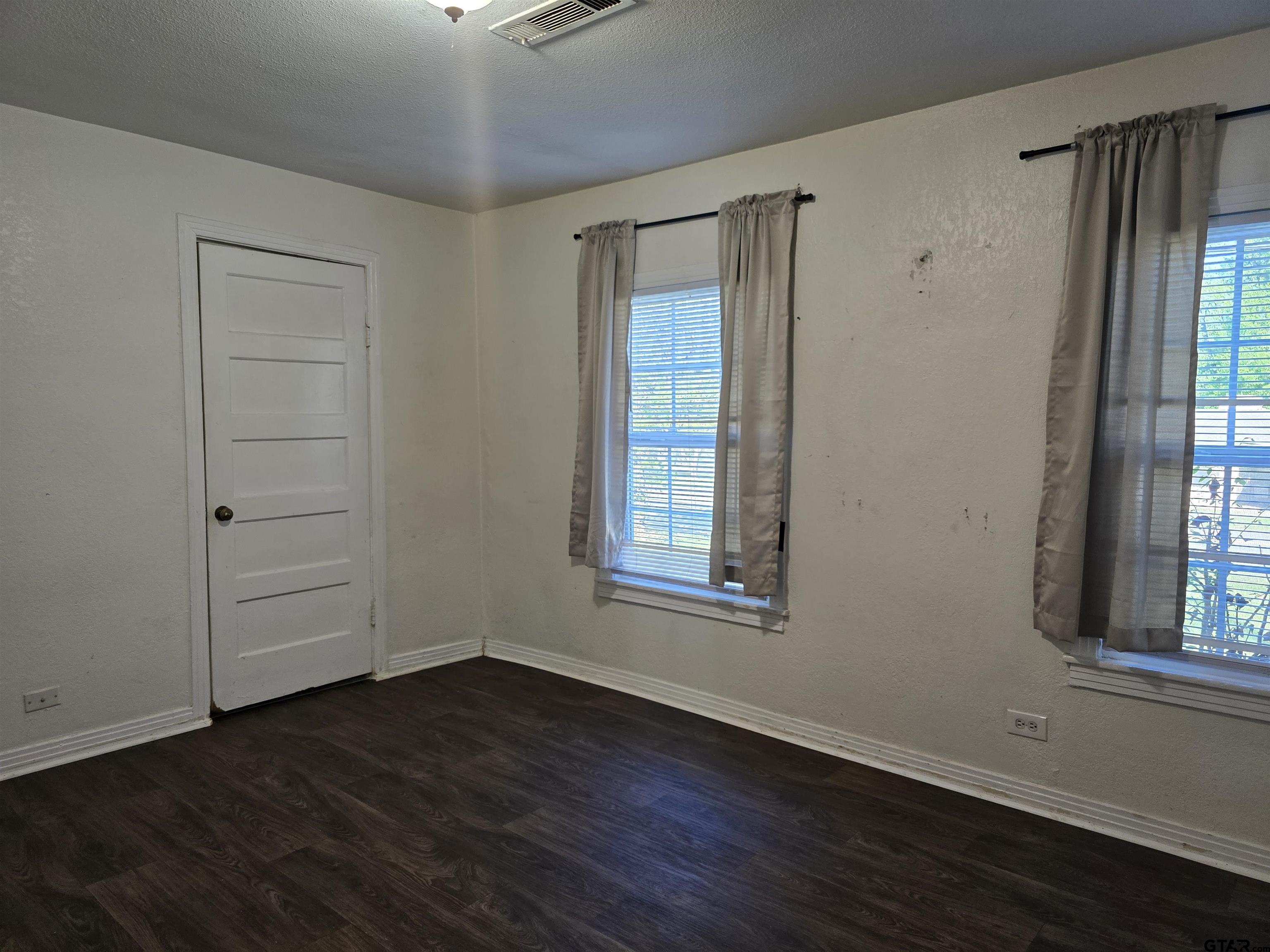 3623 New Copeland Road Tyler, TX 75701 - Photo 29 of 42 an empty room with wooden floor and windows