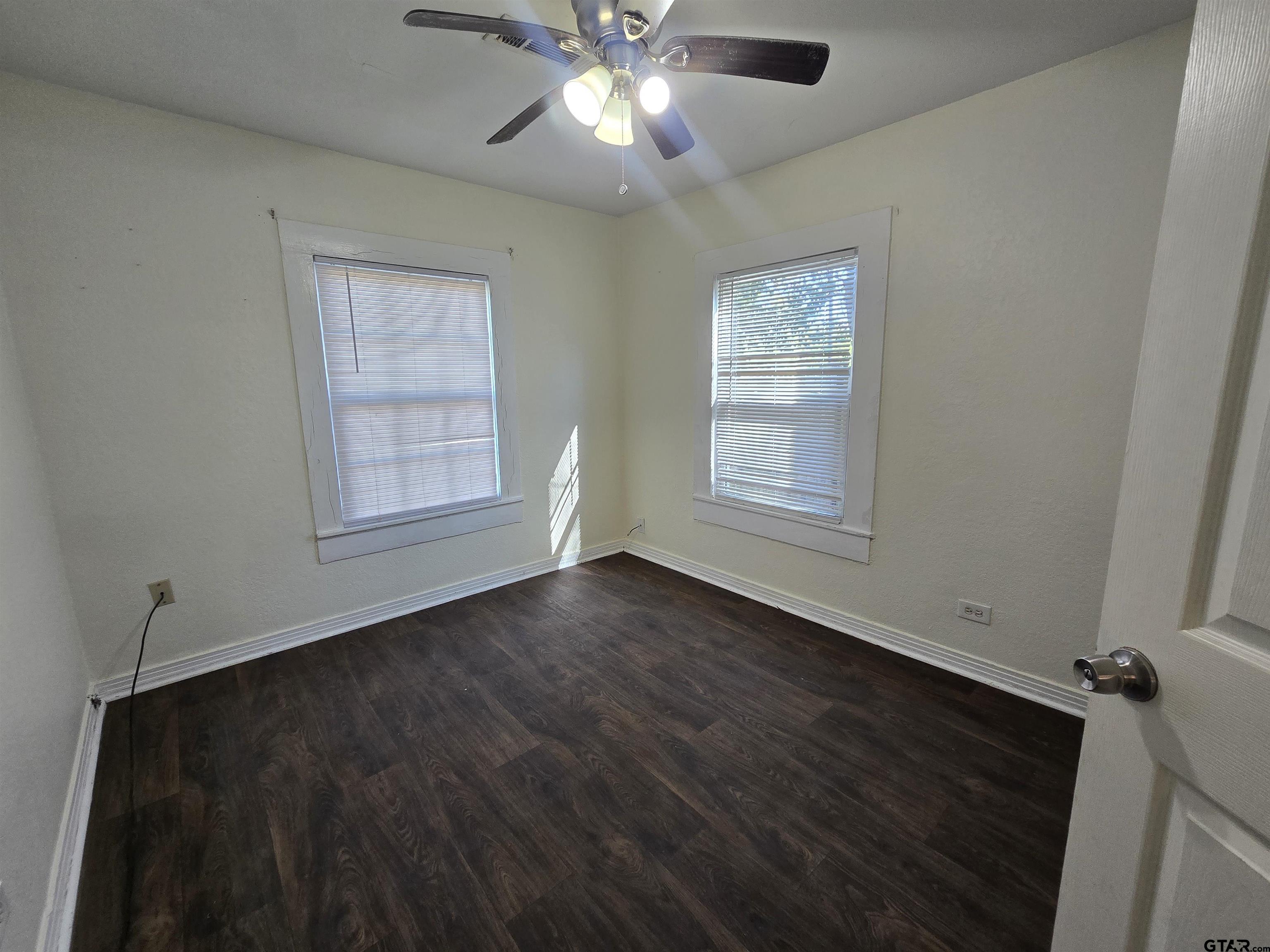 3623 New Copeland Road Tyler, TX 75701 - Photo 33 of 42 a view of an empty room with wooden floor and a window