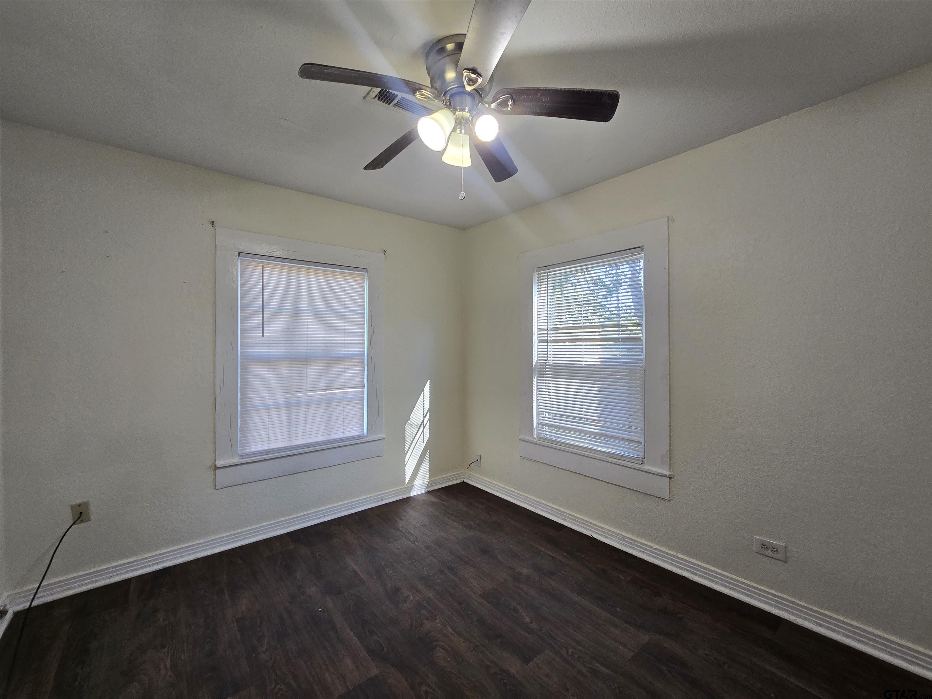 3623 New Copeland Road Tyler, TX 75701 - Photo 34 of 42 a view of an empty room with wooden floor and a window