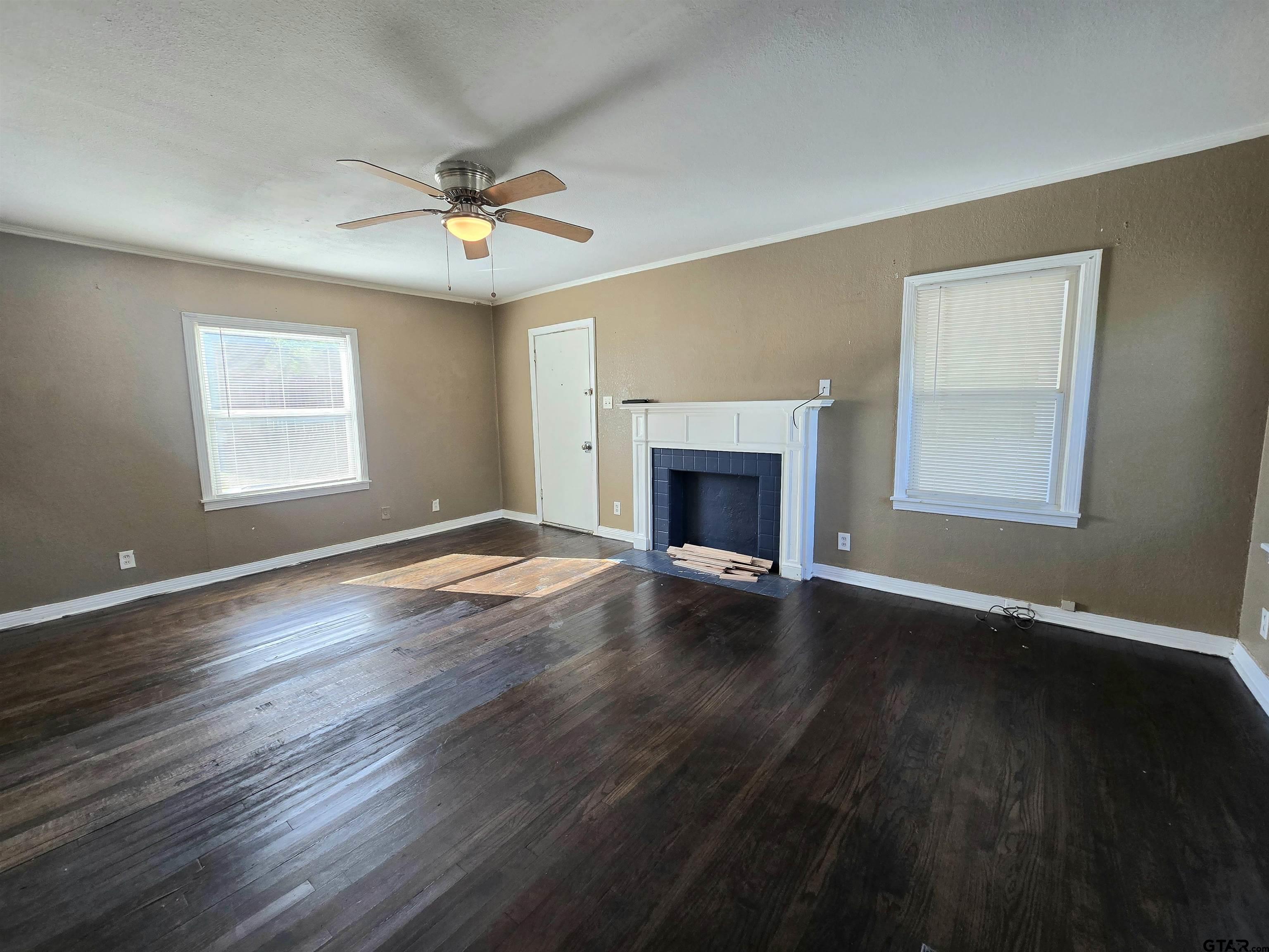 3623 New Copeland Road Tyler, TX 75701 - Photo 5 of 42 a view of an empty room with wooden floor fireplace and a window