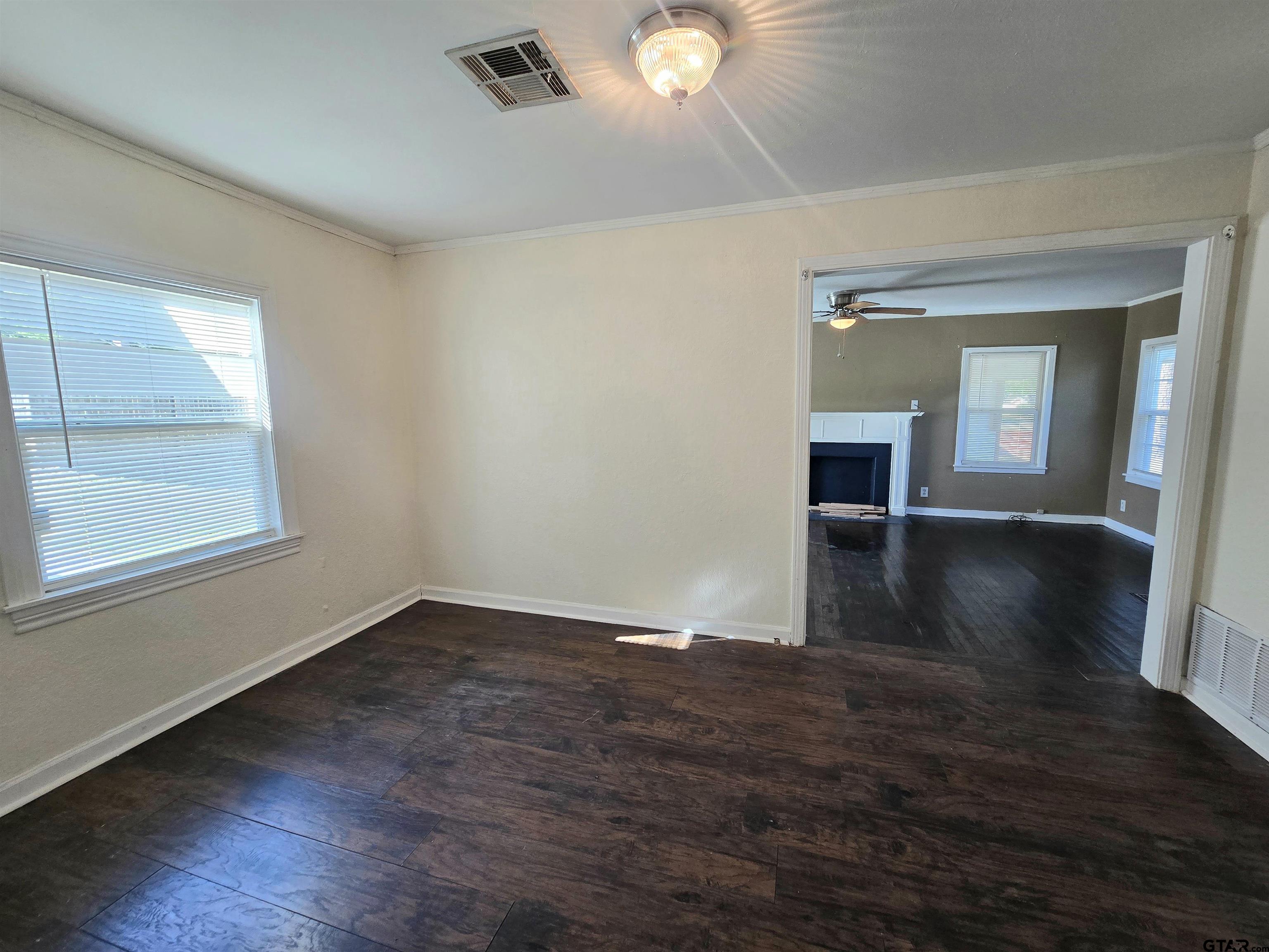 3623 New Copeland Road Tyler, TX 75701 - Photo 6 of 42 an empty room with wooden floor and windows