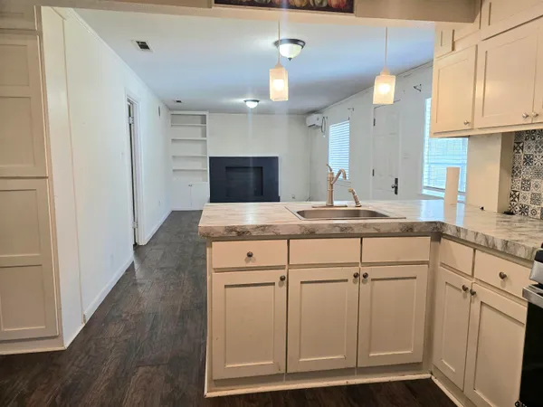 a view of a kitchen with a sink and a stove top oven