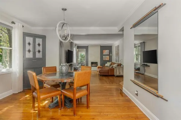 a view of a dining room with furniture window and wooden floor