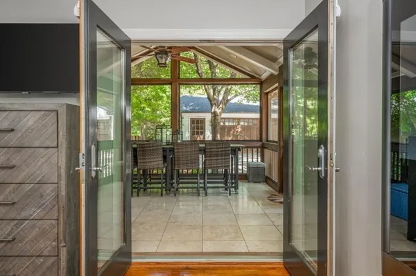 a dining room with furniture and floor to ceiling windows