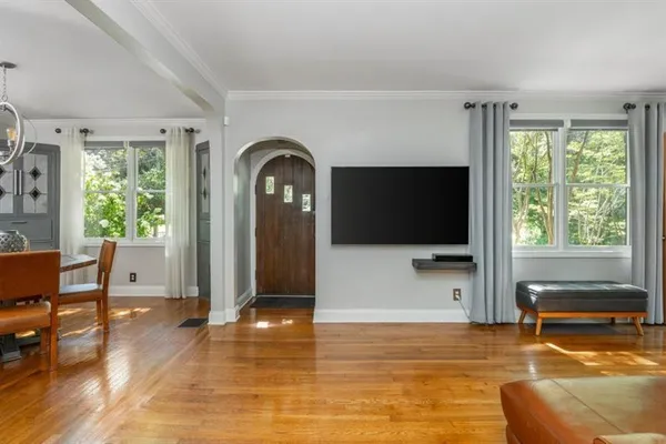 a living room with fireplace furniture and a flat screen tv