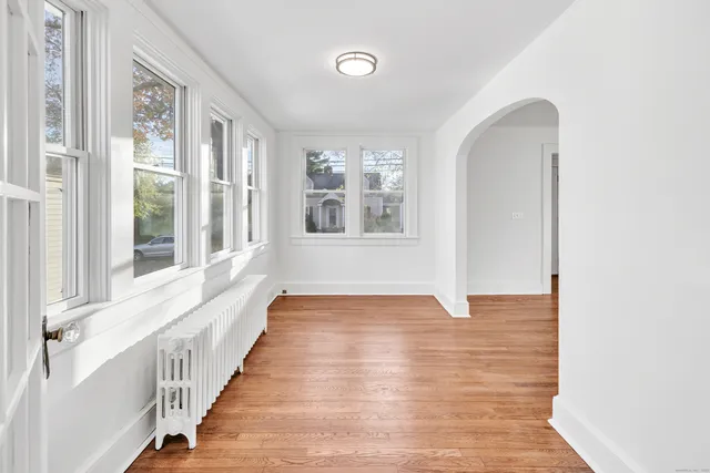 a view of a room with wooden floor and windows