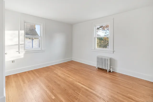 a bathroom with a granite countertop sink a mirror and a shower