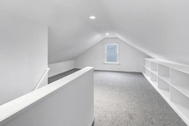 a view of an empty room with a refrigerator